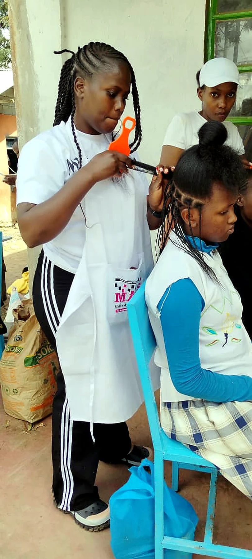 Volunteers making a child smile